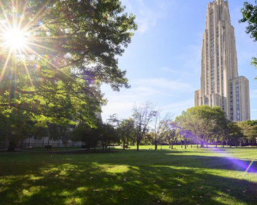 View of Cathedral of Learning across a lush green lawn